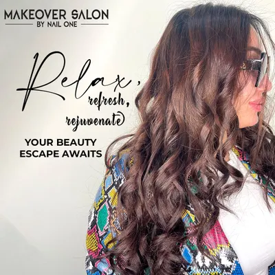 This image showcases a beautiful blowout on long, colored hair. The soft, bouncy curls add volume and glamour, perfect for a special occasion or just to feel fabulous.