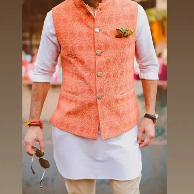 A great example of a modern ethnic look. I tailored this peach-colored Nehru jacket with a subtle woven pattern to be worn over a simple white kurta for a fresh, stylish outfit.