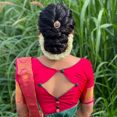 A beautiful braided updo for Vanitha for her housewarming ceremony. This elegant hairstyle is perfect for a guest who wants to look polished and festive.
