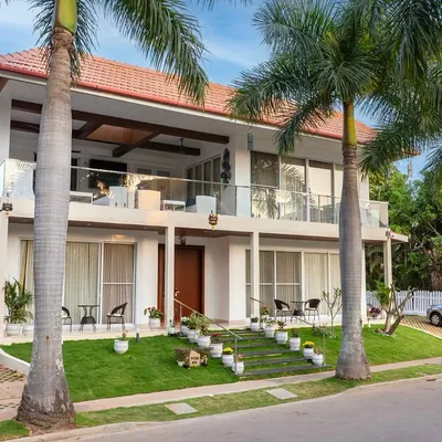 This villa is a stunning blend of modern elegance and tropical charm, with spacious balconies and lush green surroundings designed to elevate outdoor living.