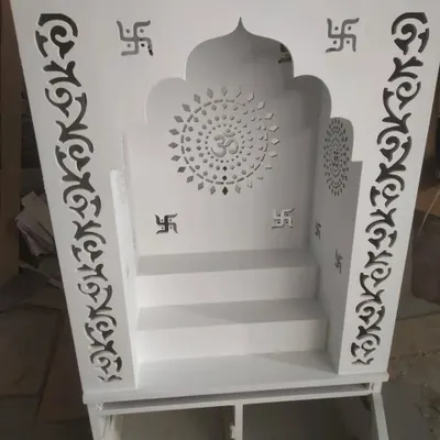 A beautiful and modern pooja unit (mandir) for the home, crafted with CNC-cut jali work featuring 'Om' and Swastik symbols.