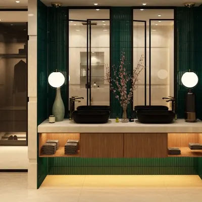 A luxurious double vanity bathroom with emerald green fluted tiles and warm backlighting. The black vessel sinks and globe lights add a touch of modern drama, creating a truly high-end look.