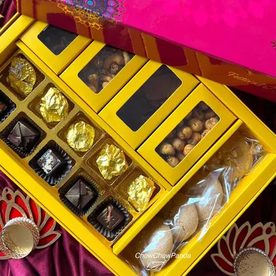This is one of my premium Diwali hampers. It includes a section of assorted foil-wrapped chocolates, compartments for nuts, and a package of homemade cookies.