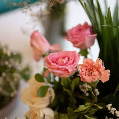 A close-up of a delicate floral arrangement featuring pink roses and carnations. These small details, when thoughtfully placed, contribute to the overall beauty and elegance of an event.