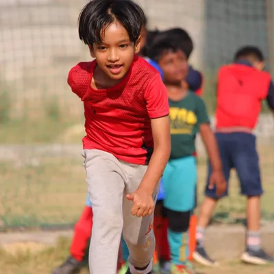 The focused energy of our summer camp. This young player gives his all during an agility drill.