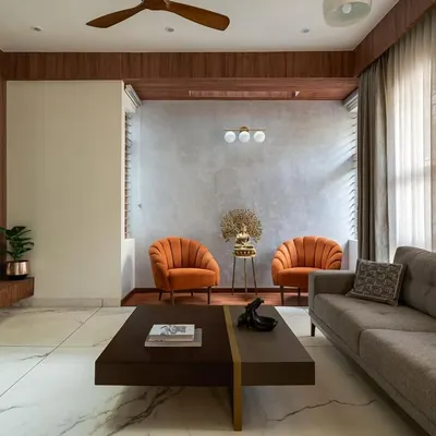 The 'Chirantana' residence is a compact 4-bedroom house where the interior design needed to be modern and efficient. This living room view shows the open layout, with a clear connection between the seating area, a quiet nook, and the TV unit.