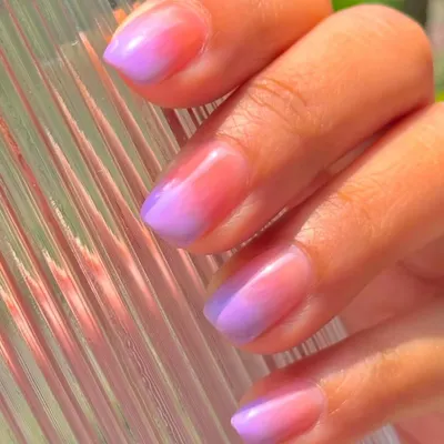 A vibrant and summery ombré effect, blending from a peachy pink at the cuticle to a lovely lavender at the tip, all with a glossy finish.