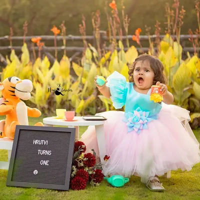 A whimsical first birthday tea party in the park. We bring everything needed, from the tiny tea set to the celebratory sign, to create a storybook scene for your child.