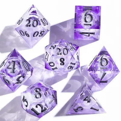 A clean, high-key shot of a set of purple gaming dice. We used hard light to create sharp shadows and highlight the intricate details and numbers on each die, making them pop against the white background.