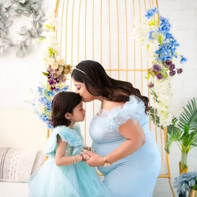 A quiet promise between a mother and her daughter. We styled this session with matching ethereal blue gowns to highlight the magical connection as they await the newest family member.