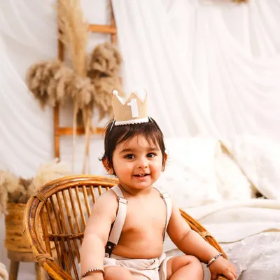 A little prince on his throne. This minimalist boho session uses natural textures like rattan and linen to create a warm and timeless first birthday portrait.