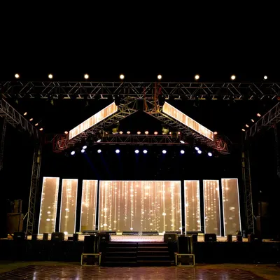 The centerpiece of a high-energy Sangeet: a massive stage with custom LED backdrops and a professional lighting rig. We design these setups to rival a live concert, ensuring every performance is spectacular.
