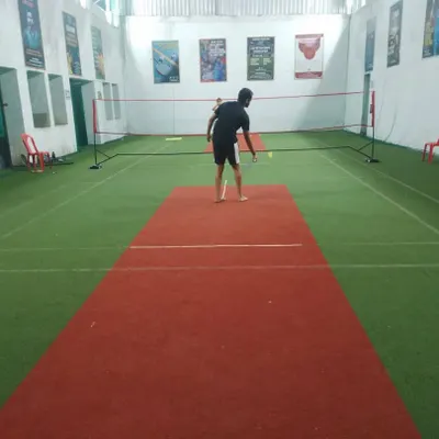 Never give up on the shuttle. A player getting ready to serve and start the point.
