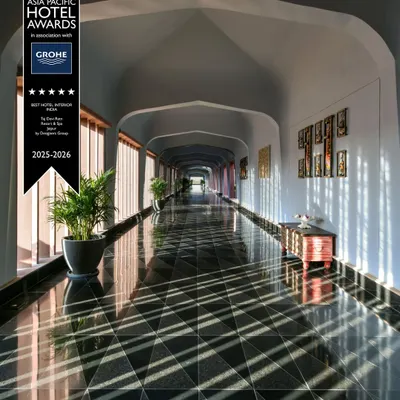 The majestic corridor at Taj Devi Ratn Resort & Spa, a project for which we received the Best Hotel Interior Award. The design features a vaulted ceiling and dramatic play of light and shadow on the patterned floor, creating an unforgettable spatial experience.