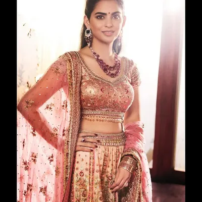Styling a client in a gorgeous peach and pink floral lehenga by Tarun Tahiliani. The look was completed with a ruby necklace for a touch of classic elegance.