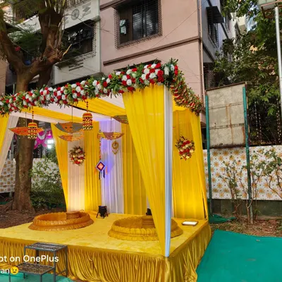 A beautiful outdoor Haldi ceremony setup. I created a mandap with yellow drapes, decorated with traditional hangings and floral arrangements, and provided two baithaks for the rituals.