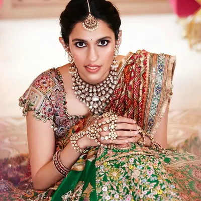 This custom Anamika Khanna lehenga is one of my all-time favorites. The blend of green and red with intricate, multi-colored embroidery and a stunning dupatta makes it a true masterpiece for a bride.