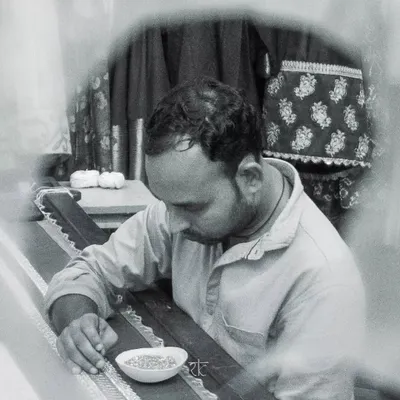 An artisan at work, meticulously hand-embroidering a design. This is where the magic happens, stitch by stitch.