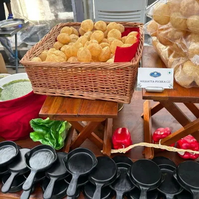 A classic Indian street food favorite, Puchka (Pani Puri), ready to be served. We present it with all the traditional accompaniments for an authentic experience.