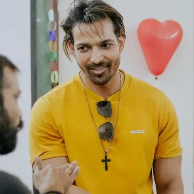 A candid shot of actor Harshvardhan Rane interacting with someone off-camera, capturing a natural and engaging moment.