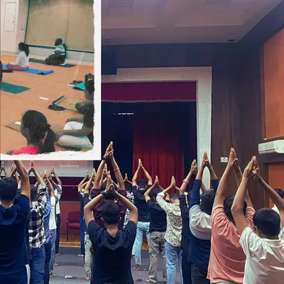 A large group of participants stand with hands in 'Namaskar', a gesture of reverence. My workshops are designed for everyone, creating a space to explore yoga as a tool for conscious living.