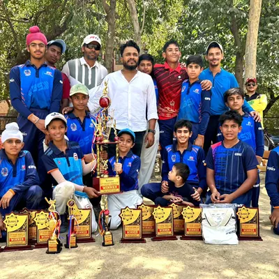 A proud moment with the team after a successful tournament. We are surrounded by the trophies that represent their hard work and dedication.