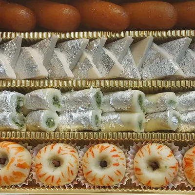 Our assorted mithai box is perfect for gifting or celebrating any occasion. This one includes a vibrant mix of our bestsellers like Kaju Katli, Pista Rolls, and decorative sandesh, all handcrafted in our kitchen.