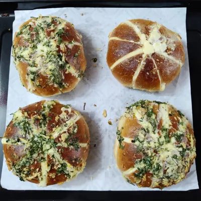 A tray of freshly baked Korean Cream Cheese Garlic Buns. You can see the generous garlic and herb topping over the golden-brown crust, with the cream cheese filling peeking through.