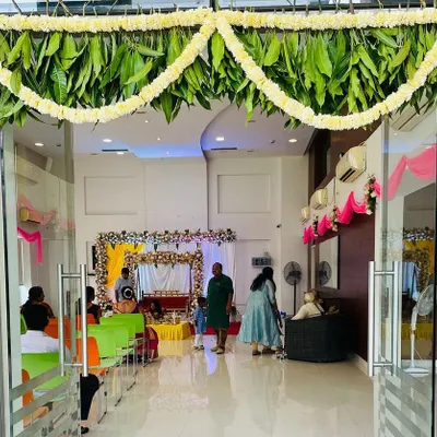 This is a traditional entrance I decorated for a housewarming ceremony. The frame is adorned with classic marigold and leaf garlands, creating an auspicious and warm welcome for guests entering the new home.