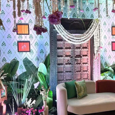 A closer look at the traditional wooden door and floral garlands, key elements of our South Indian themed baby shower decor.