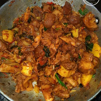 A close-up of my spicy pork and bamboo shoot stir fry, cooked until tender in a traditional kadai.