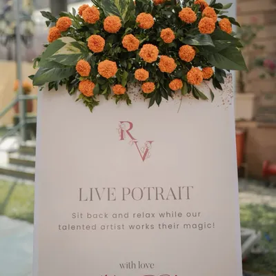 We love adding unique experiences for guests. This sign for a "Live Portrait" station invited guests to sit back and have their portrait painted, giving them a beautiful, personalized keepsake from the Haldi ceremony.