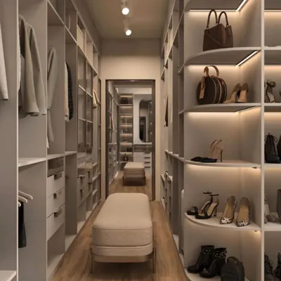 A long, galley-style walk-in closet featuring ample hanging space and specialized curved shelving for shoes and bags. Integrated LED lighting under each shelf ensures every item is visible and beautifully displayed.