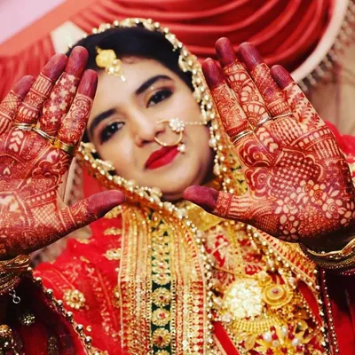 The joy on a bride's face and the beautiful red stain of her henna is what makes my work so rewarding. This professional shot shows how the mature henna stain looks on the wedding day.