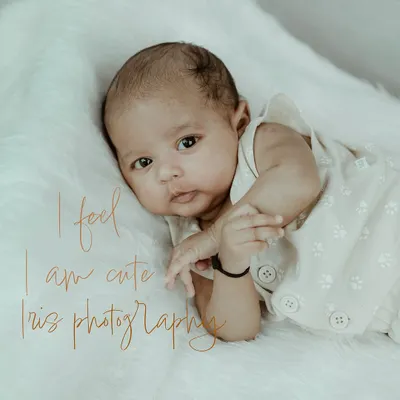 An adorable newborn portrait where the baby is awake and looking directly at the camera. This shot captures the early curiosity and delicate features of a brand new baby.
