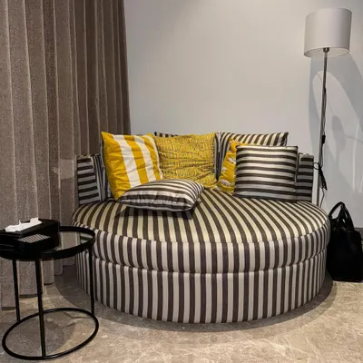 Every bedroom deserves a cozy reading corner. I custom-made this oversized round couch in a bold striped fabric for a client to create the perfect comfortable nook.