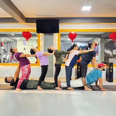 A human train created through a group yoga pose. This fun and challenging formation requires everyone to work together, symbolizing support and interconnectedness within a team.