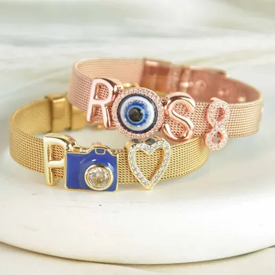 Don't miss out on these bracelets. You can customize them with your name, initials, and a wide variety of personal charms like this cute camera or evil eye.