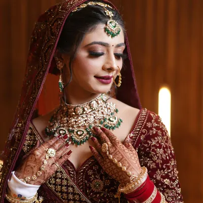 A radiant bride, her beauty enhanced by exquisite jewelry and a confident smile. I focus on capturing the details, from the intricate necklace to the sparkle in her eyes.