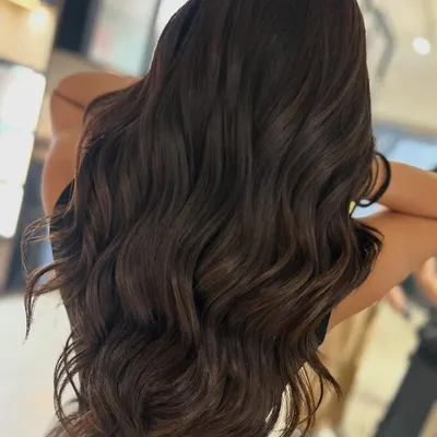 Hot chocolate season is here. This warm brown two-tone color features subtle peekaboo highlights that add dimension while maintaining an overall rich, dark look.