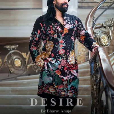 I believe clothing should tell a story. This black kurta is a canvas of intricate, multi-colored embroidery, featuring florals and tigers for a look that is pure royalty. The addition of a traditional turban completes this powerful statement.