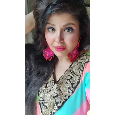 This is my rainbow kaftan, a celebration of being the best woman you can be. The vibrant colours and easy fit, paired with hand-embroidered earrings, make it a perfect piece for the festive season.