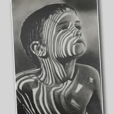 This realistic pencil portrait by Ayush Agnihotri uses the interplay of light and shadow to create a striking effect. The zebra-like stripes on the child's face produce a captivating and thought-provoking image.