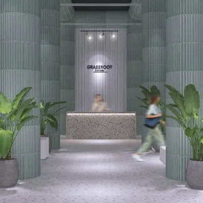 The entrance of the GRASSROOT store, designed to feel like a modern sanctuary. The combination of terrazzo, soft green columns, and plants creates a natural and welcoming threshold for shoppers.