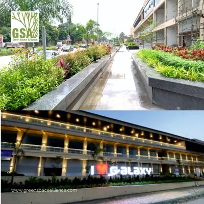 The Galaxy Hub in Ambernath, a dynamic commercial complex we designed. The images show the lively urban plaza with its linear paving and the building's illuminated facade at night, demonstrating how our design has created a go-to destination for local residents.