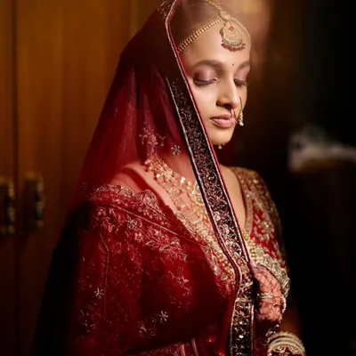 A quiet moment of reflection for my beautiful Gujarati bride, Laxmi. Her soft glam makeup, with warm tones on the eyes, was designed to complement the rich, traditional red of her wedding attire.