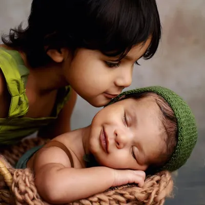 Aren't moments like these just everything? I love capturing the pure, gentle love between siblings. This big sister was so in awe of her new baby brother, and that little smile on his face is just priceless. These are the sibling photos you'll treasure forever.