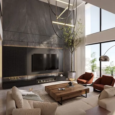 For this Pune apartment, I designed a dramatic living space with a double-height ceiling and a striking stone-clad feature wall. The modern fireplace and custom television unit are integrated seamlessly, while the sculptural chandelier adds an artistic focal point.