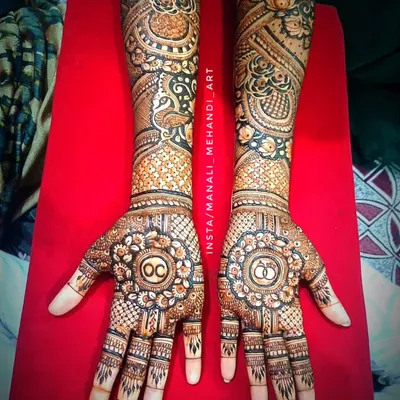 A full bridal-style mehandi for an engagement ceremony. This intricate design includes the couple's initials and engagement ring symbols, surrounded by peacock and floral patterns.