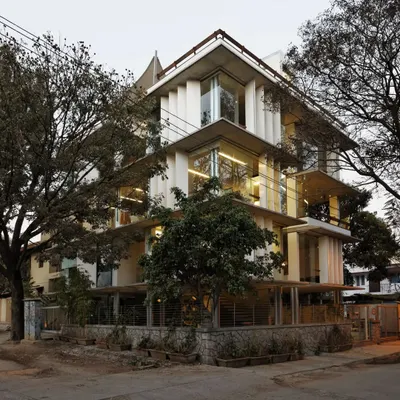 The Nirvana Films Studio in Bengaluru is designed to dissolve the boundaries between inside and out. The building's transparent facade and operable louvres allow the workspace to be immersed in the surrounding trees, creating a tranquil and inspiring atmosphere for a creative ad film company.